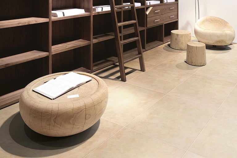 Heller Raum mit Fliesenboden, Holztisch, Holzregal und Holzleiter