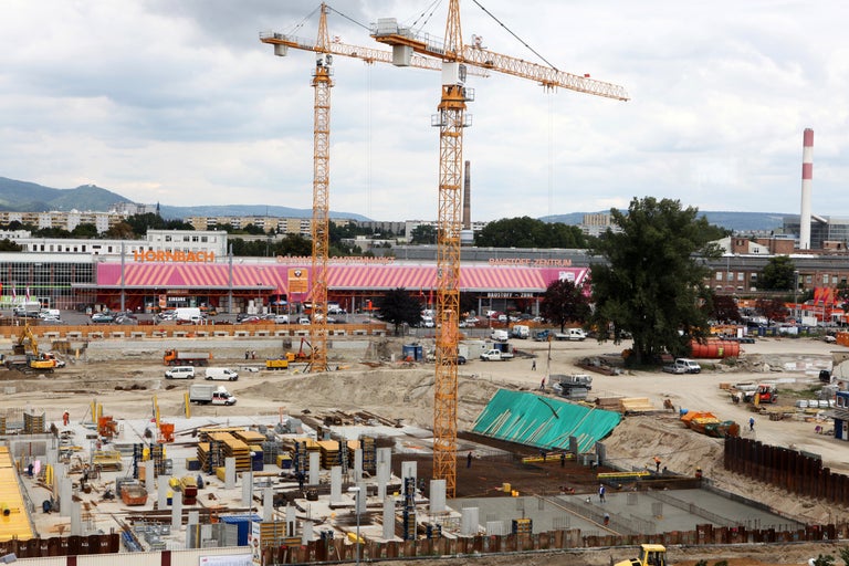 Baustelle mit Baukränen vor einem Hornbach Baumarkt.