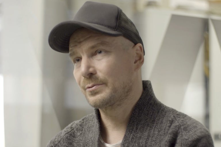 Porträt eines Mannes mit Strickjacke und Schirmmütze