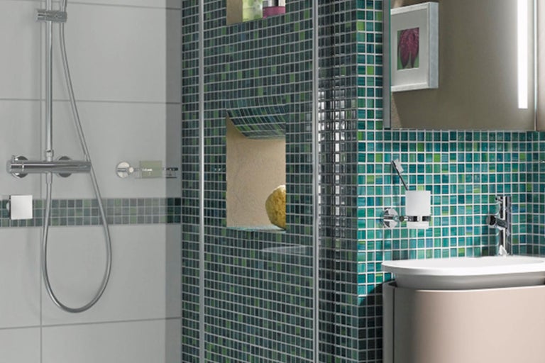 Badezimmer mit Dusche, Waschbecken und Mosaikfliesen