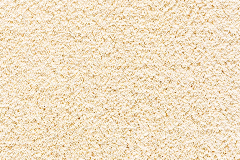 Nahaufnahme eines beigen Teppichs