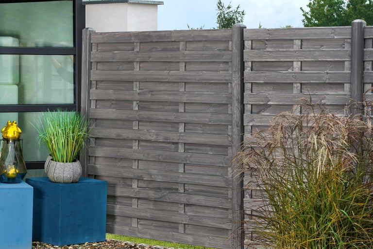 Gartenzaun aus Holz mit Pflanzen und Dekoration