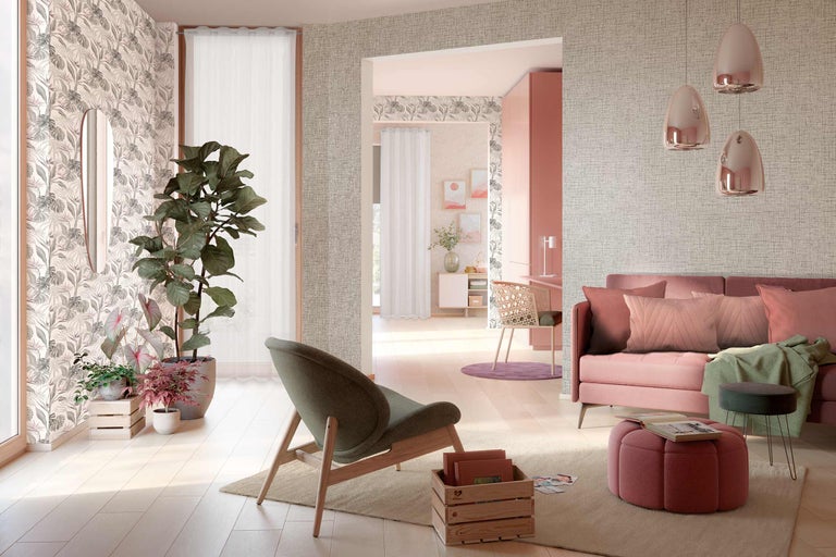 Wohnzimmer mit Sofa, Sessel, Pflanzen und dekorativer Wandgestaltung für ein gemütliches Ambiente