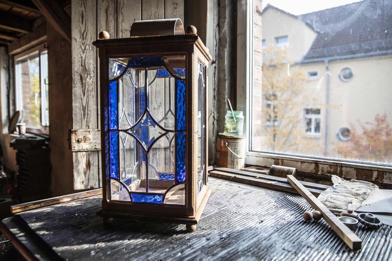Dekorative Laterne aus Holz und Glas mit blauen Akzenten
