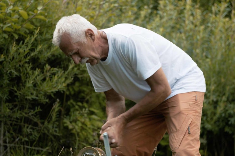 Mann bedient Bewässerungssystem im Garten