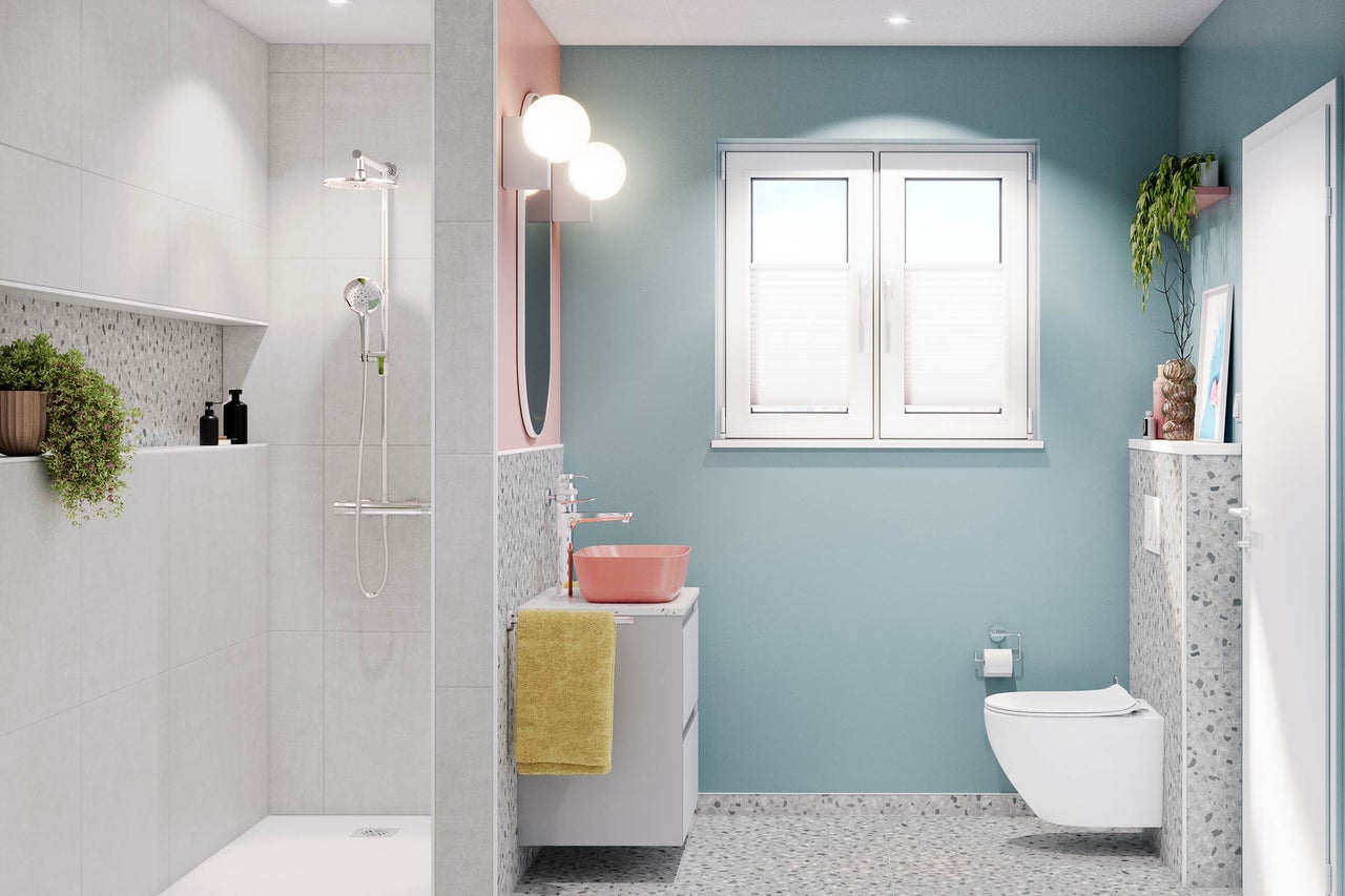 Modernes Badezimmer mit Dusche, Waschtisch und Toilette.