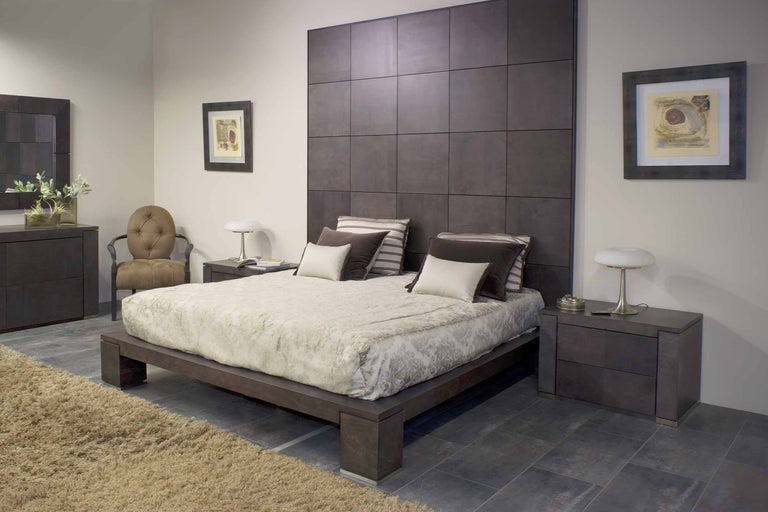 Schlafzimmer mit Bett, Nachttischen, Kommode und Stuhl in einem hellen Raum