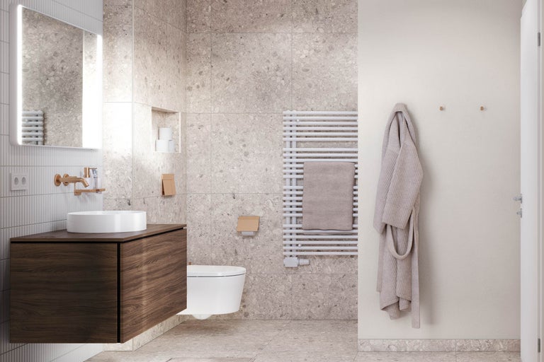 Modernes Badezimmer mit Waschtisch in dunkler Holzoptik, weißem Aufsatzbecken, beleuchtetem Spiegel und großformatigen Terrazzo-Fliesen.