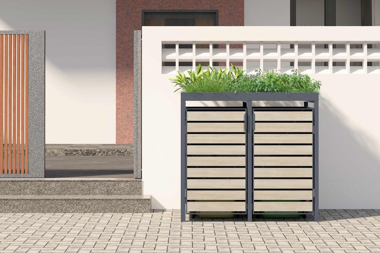 Doppelter Mülltonnenbox mit Pflanzwanne vor einem Haus