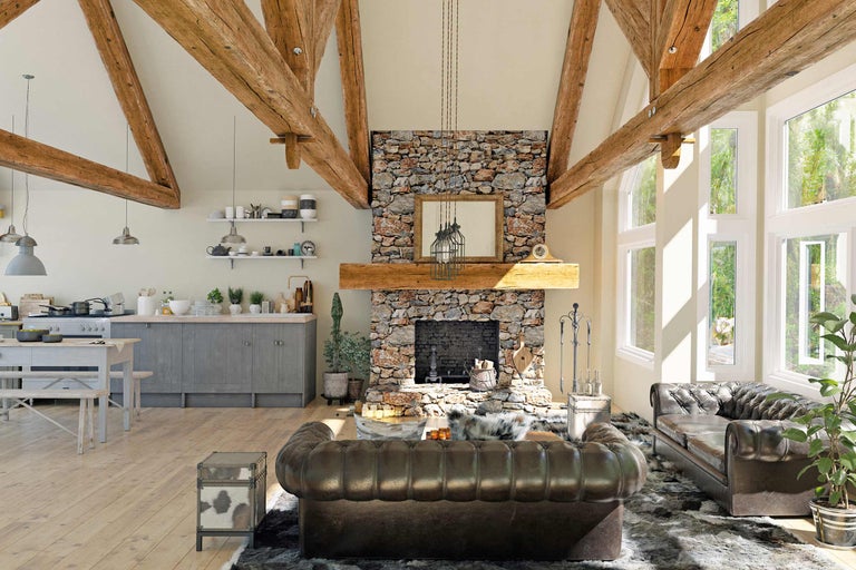 Heller Wohnraum mit Holzbalken, Steinkamin und Ledersofas
