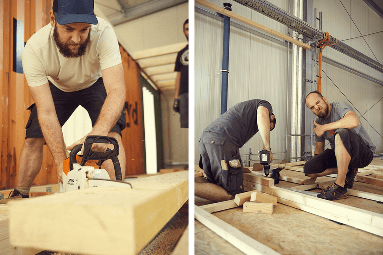 Auf dem Bild sind zwei Handwerker bei der Holzbearbeitung zu sehen, einer sägt ein Brett mit einer Kettensäge und der andere montiert Holz mit einem Akkuschrauber.