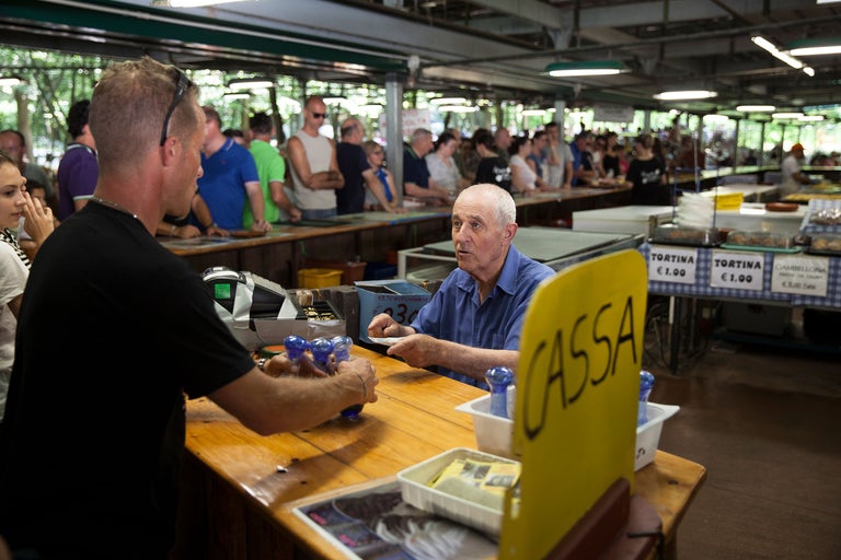 Szene einer Essensausgabe mit Warteschlange und Kasse