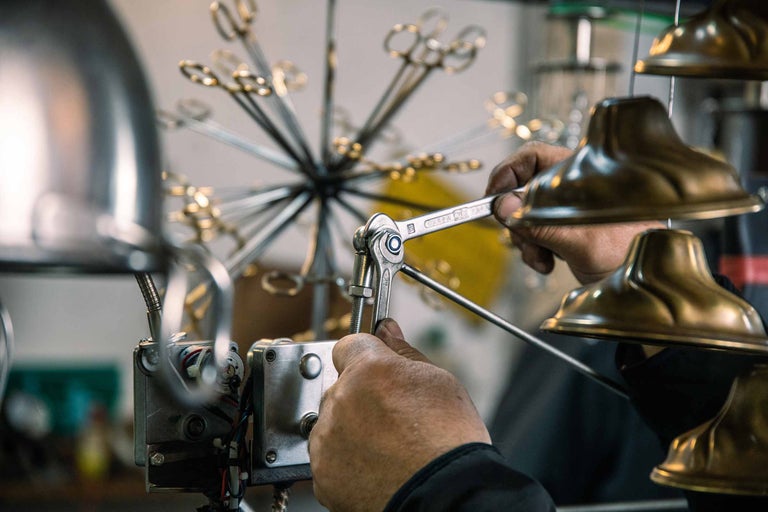 Ein Mann benutzt einen Schraubenschlüssel, um ein Gerät zu reparieren.