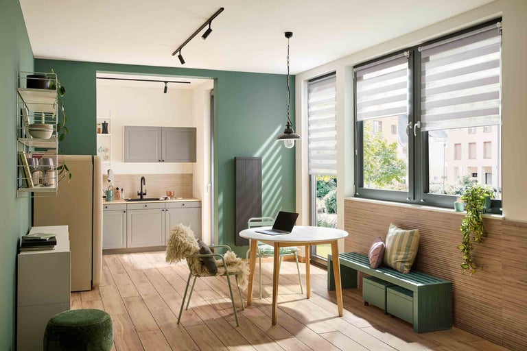 Heller Wohnraum mit Esstisch, Stühlen und Küchenzeile