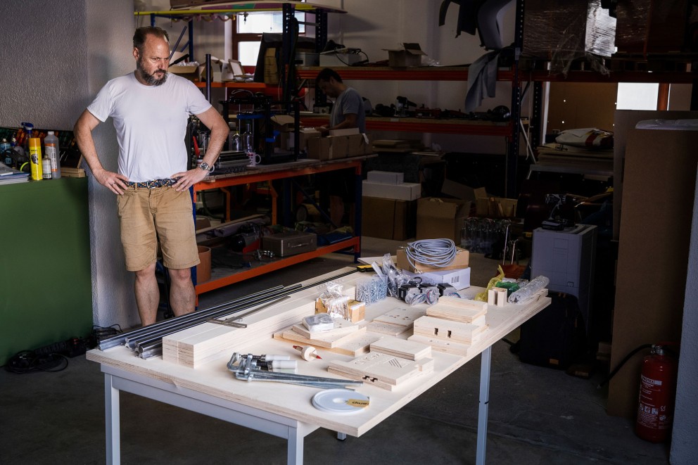 In einer Werkstatt steht der Tisch mit allen Materialien für die CNC14: Holz, Metallschienen, Motoren, Kabel, Elektronik. In einer Werkstatt steht der Tisch mit allen Materialien für die CNC14: Holz, Metallschienen, Motoren, Kabel, Elektronik.
