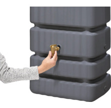 Grauer Regenwassertank mit goldenem Auslaufhahn und Hand