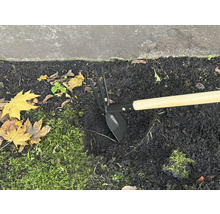 Gartenhacke mit Holzstiel im Beet