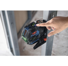 Bosch Professional Linienlaser mit Hand an Metallkonstruktion befestigt