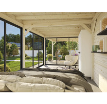 Helles Zimmer mit Holzbalkendecke, Bett und Blick durch Fenster auf Garten