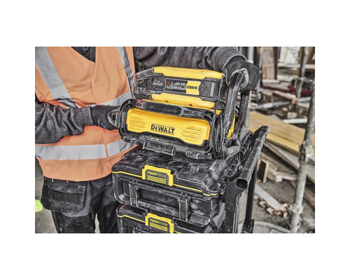 Eine Person transportiert einen DeWalt Toughsystem Werkzeugkoffer auf einem Rollwagen.