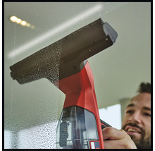 Fensterreiniger im Einsatz auf einer Glasoberfläche