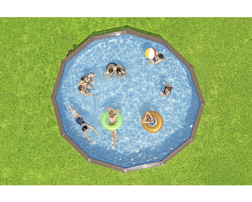 Aufnahme von oben: Achtkantiges Schwimmbecken mit Menschen auf einer Rasenfläche.