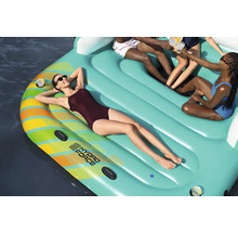 Aufblasbare Badeinsel mit mehreren Personen auf dem Wasser.