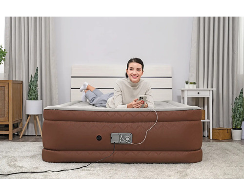 Frau liegt auf Luftmatratze mit integrierter Pumpe im Schlafzimmer