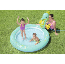 Aufblasbarer Kinderpool mit Wassersprinkler in Form eines Seepferdchens im Garten mit spielenden Kindern