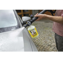 Eine Person verwendet einen Kärcher Universalreiniger mit Hochdruckreiniger, um ein Auto zu waschen.