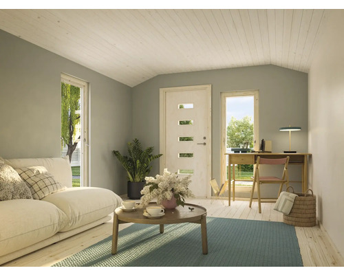 Wohnzimmer mit Sofa, Couchtisch, Schreibtisch und Holzboden