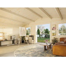 Helles Gartenhaus-Interieur mit Atelierbereich, Sofa und Blick in den Garten