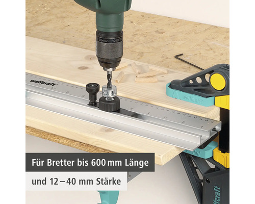 Wolfcraft Dübelleiste mit Bohrmaschine und Holzdübeln auf Holzbrett