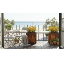 Balkonszene mit Tisch, Stühlen, Pflanzgefäßen und Meerblick für eine entspannende Atmosphäre