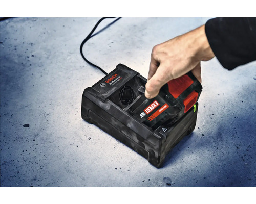 Aufsicht auf ein Ladegerät der Marke Bosch, in das ein Akku eingesetzt wird.