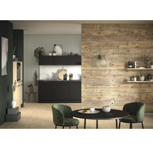 Moderne Küche mit schwarzen Fronten, weißem Fliesenspiegel und Akzentwand aus Holz. Davor ein runder schwarzer Tisch mit grünen Polsterstühlen.