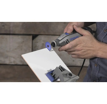 Dremel Multifunktionswerkzeug beim Schneiden einer weißen Fliese mit einer Trennscheibe.