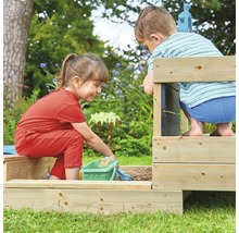 Zwei Kinder spielen in einem Sandkasten aus Holz im Garten.