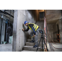 Mann verwendet einen Laser zur Ausrichtung auf einer Baustelle