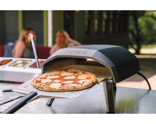 Ooni Pizzaofen mit Pizza auf einem Pizzaschieber
