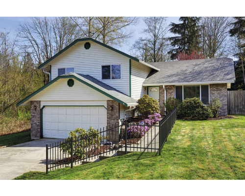 Haus mit Garage, Zaun und Garten