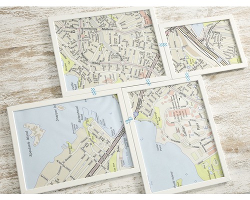 Vier weiße Rahmen mit Kartenausschnitten