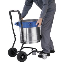 Industriestaubsauger auf einem Wagen mit Rädern wird von einer Person bedient