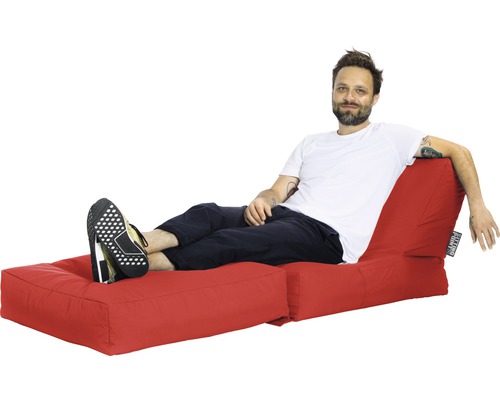 Mann entspannt auf einem roten Sitzsack mit Fußstütze