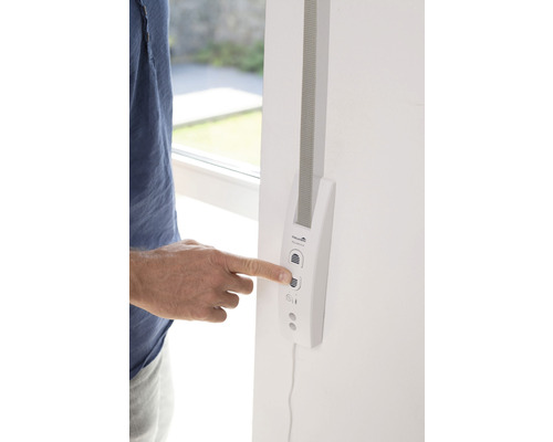 Person bedient einen elektronischen Gurtwickler an einer Wand