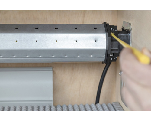 Rollladenmotor wird mit einem Werkzeug eingestellt.