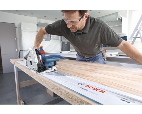 Handwerker schneidet Holz mit einer Bosch Tauchsäge und Führungsschiene.