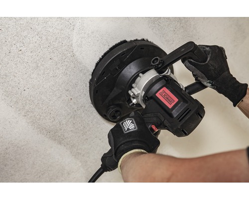 Handwerker mit einer Trockenbauschleifer an einer Wand