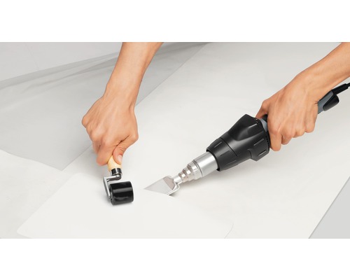 Handwerker verschweißt Folie mit einem Schweißgerät und einer Andrückrolle