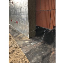 Außenwanddämmung mit Mineralwolle und Aluminiumkaschierung an einem Gebäude.